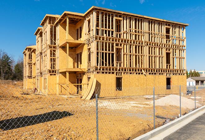 a job site enclosed by temporary chain link fences, ensuring safety for workers and pedestrians in Hillsboro